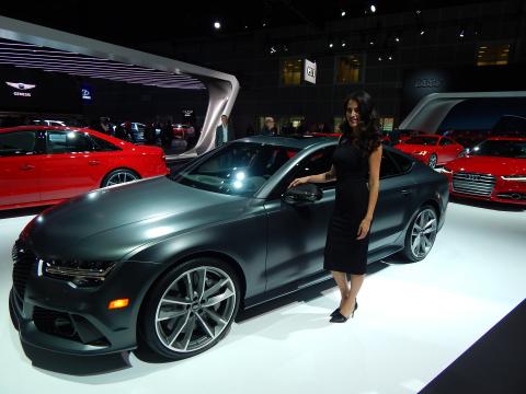 Female model standing next to an Audi RS7