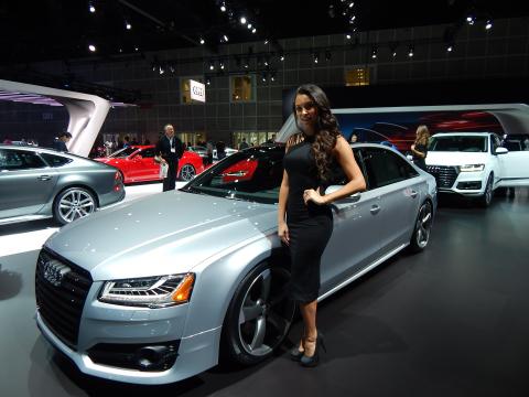 Female model standing next to an Audi A8